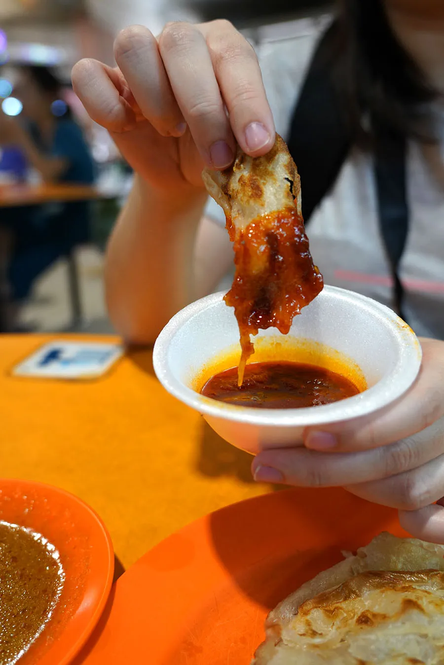 Prata dipped in curry