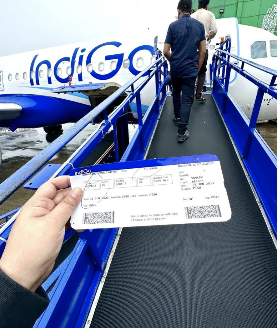 Flight ticket infront of a plane