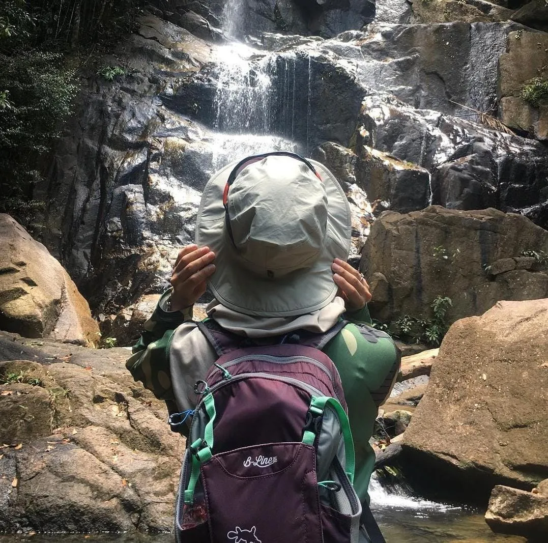 a woman infront of a waterfall