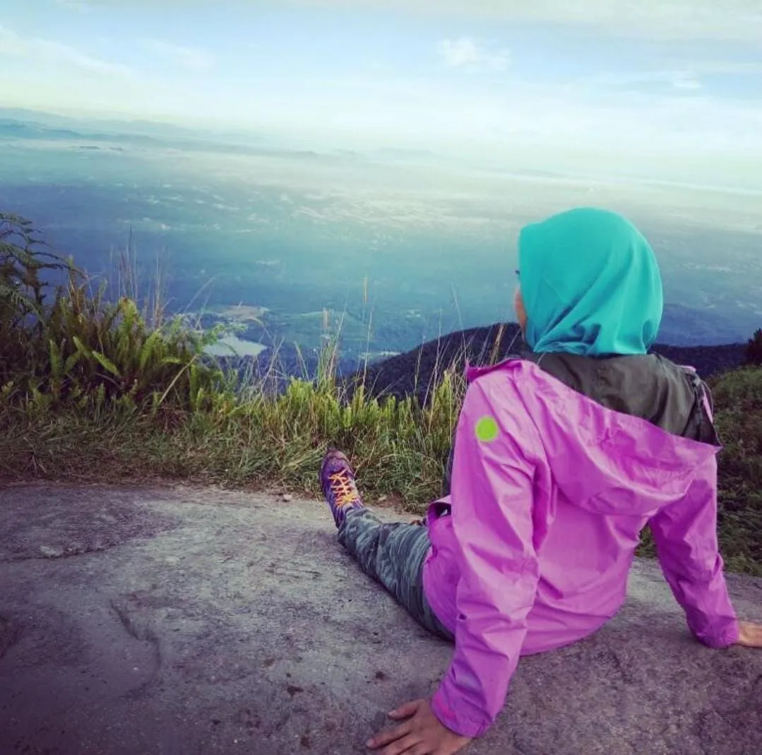a woman at the summit of a mountain